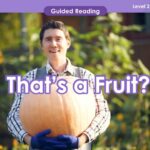 A teacher holding a pumpkin with the text that's a fruit?