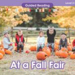 A teacher guides reading at a fall fair using lesson plans and teaching resources.